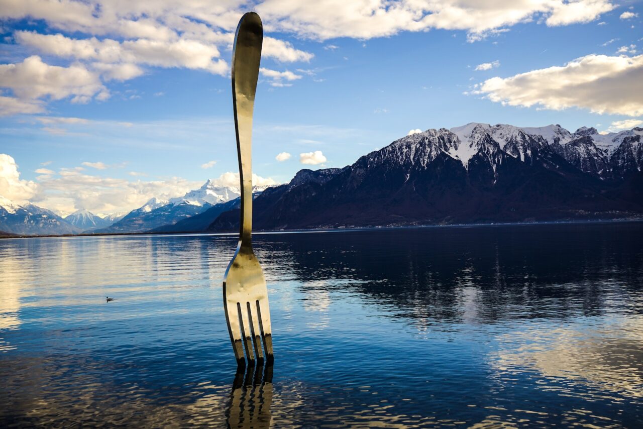 Gray Stainless Steel Fork on Water With Overlooking Mountain at Daytime